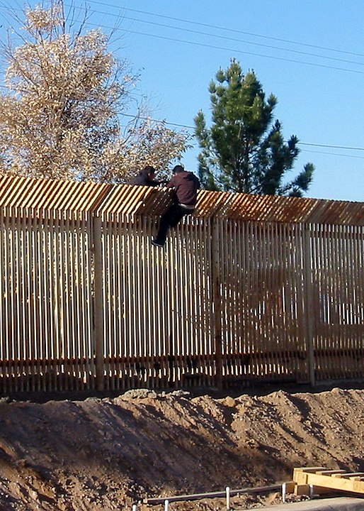 2 men scale the border fence